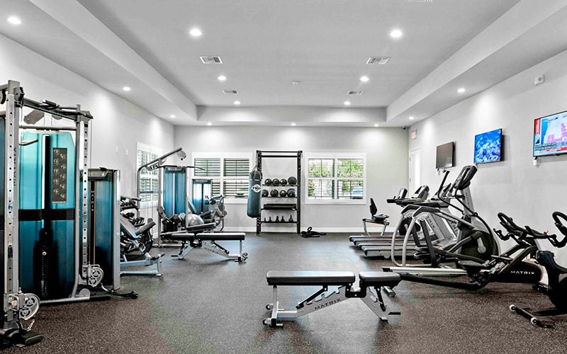 Fully-equipped fitness center with interactive workouts and recessed lighting throughout