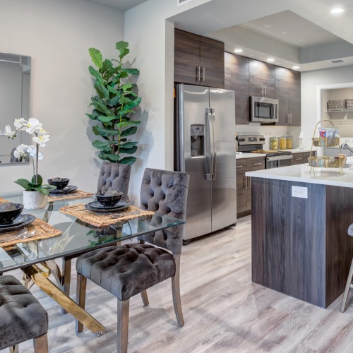 Dedicated dining areas Dining area open to kitchen with island in apartments at The Reef at Winkler